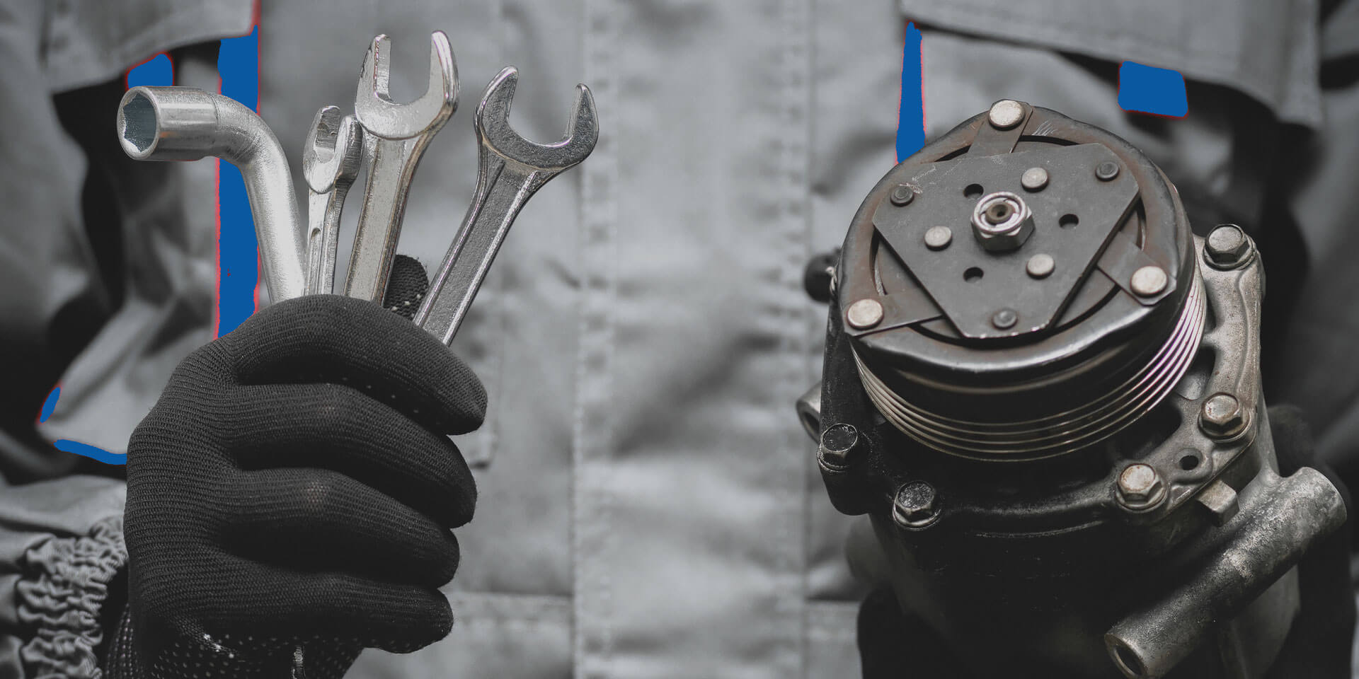 a mechanic holding wrenches and a car part - Used Car Parts concept image