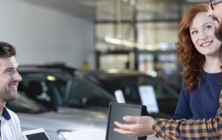 couple speaking with dealership manager