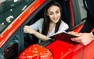 Salesman helping woman with vehicle