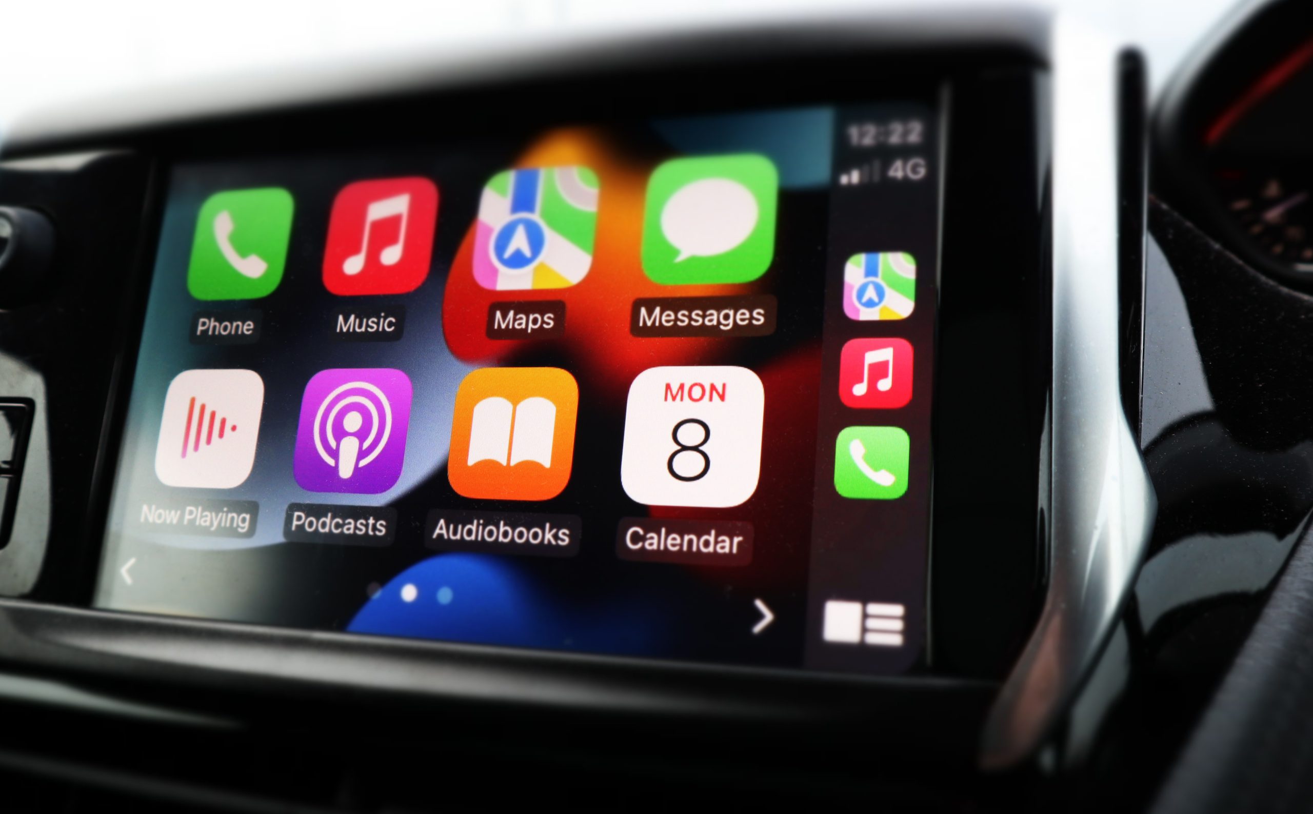 SWINDON, UK – NOVEMBER 8, 2021: In Car Apple Car Play system, Apple Car Play was created and developed by the Apple inc. Mechanic working on used vehicle - BENEFITS OF A USED TOYOTA concept image