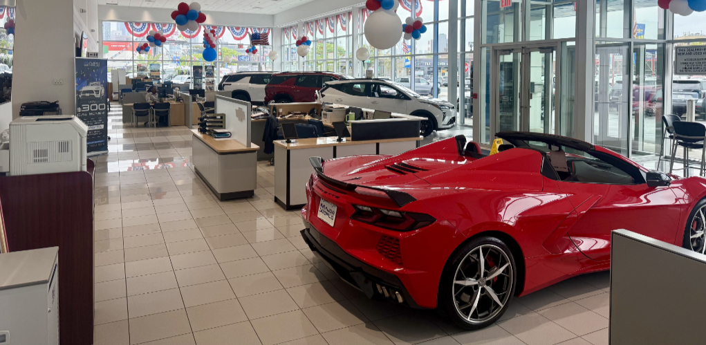 Dealership show room with red and white cars