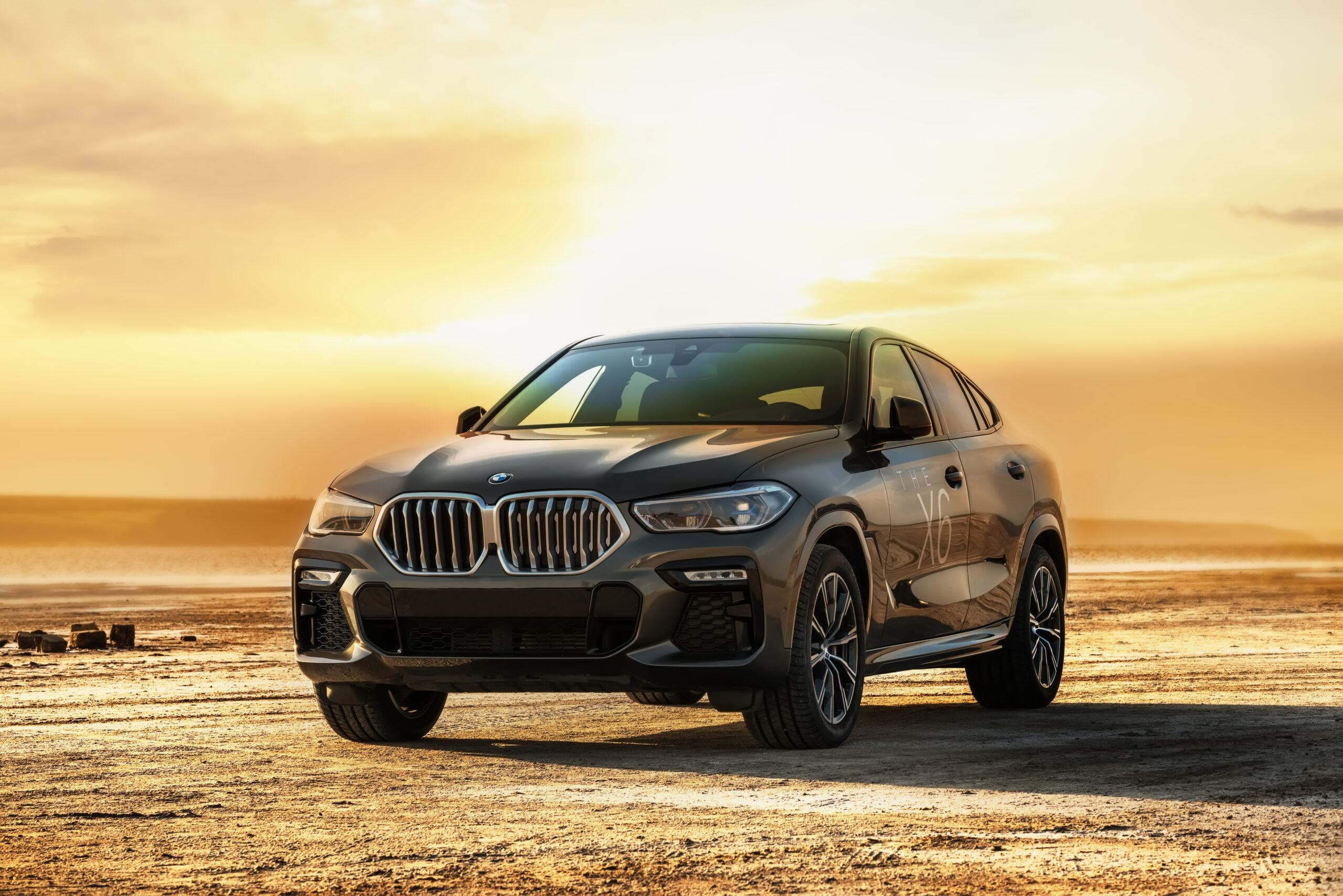**Black BMW luxury SUV parked on a desert landscape at sunset, featuring a bold kidney grille, sleek LED headlights, and premium styling.** **Black BMW luxury SUV parked on a desert landscape at sunset, featuring a bold kidney grille, sleek LED headlights, and premium styling.**